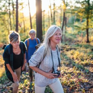Older people on a hike through the woods.