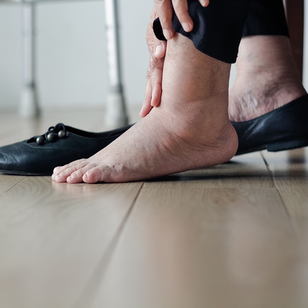 Senior with hand on foot and ankle