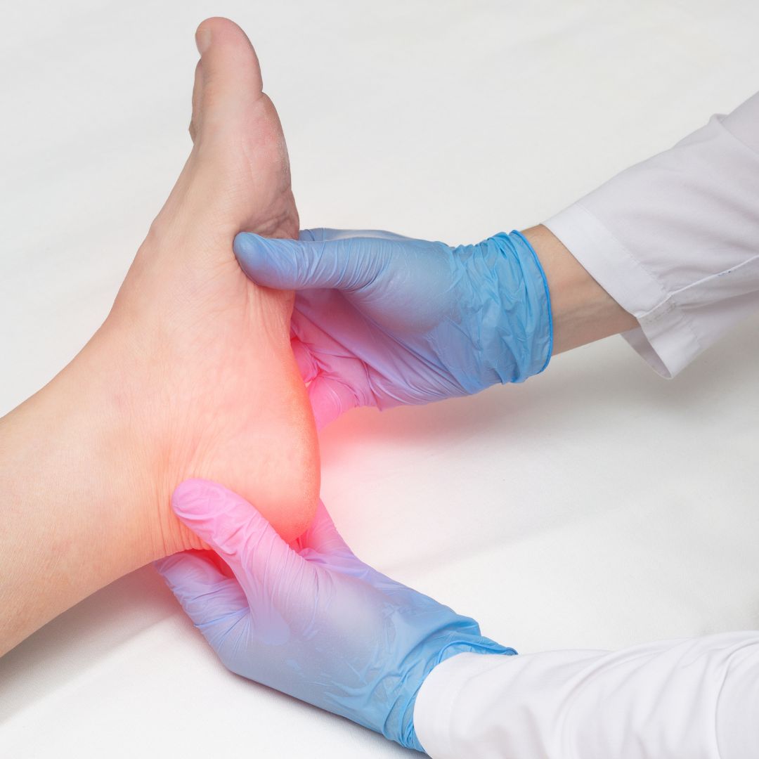 doctor with gloved hands inspecting patient's foot